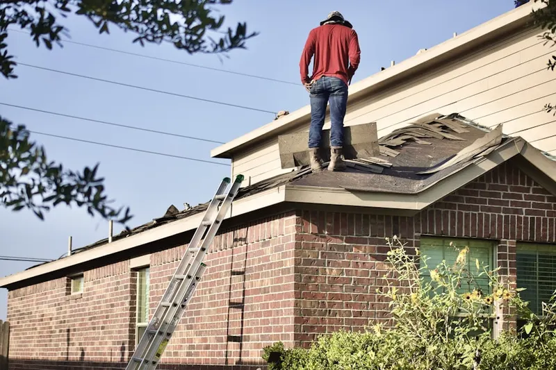 Professional roofer working on a residential roof in Sunset Ridge